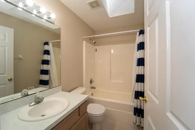 a bathroom with a glass shower door