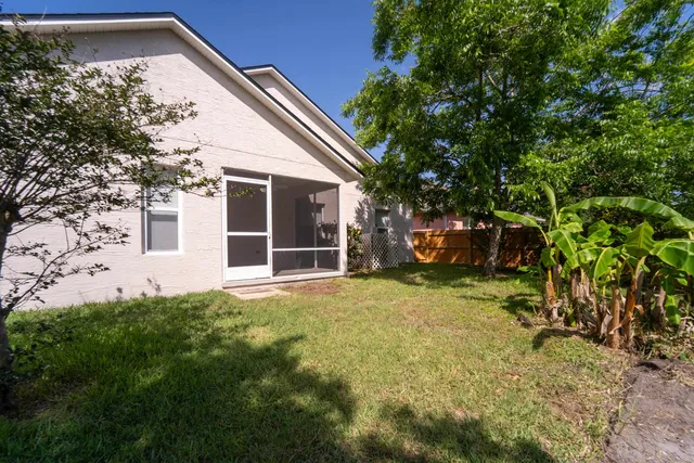 a view front of house with backyard and trees