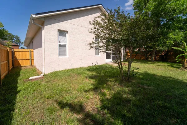 a house that is sitting in middle od the grass