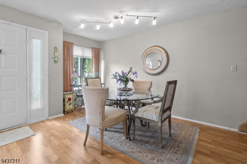 3701 Park Place Springfield, NJ 07081 - Photo 3 of 38 a dining room with furniture a chandelier and wooden floor