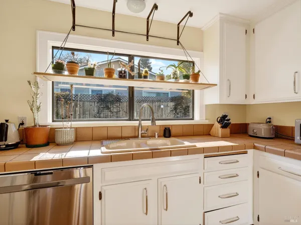 a kitchen with stainless steel appliances granite countertop a stove and a sink