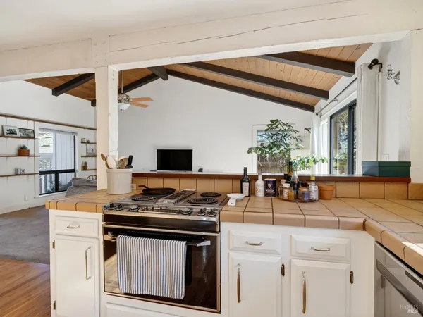a kitchen with refrigerator and cabinets