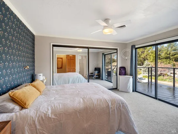a bedroom with a large bed and a large window