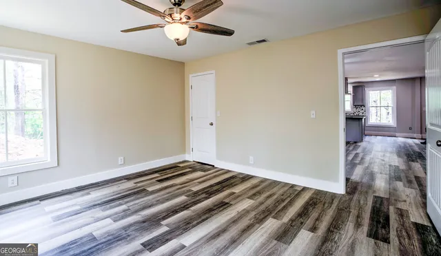 wooden floor in an empty room with a window