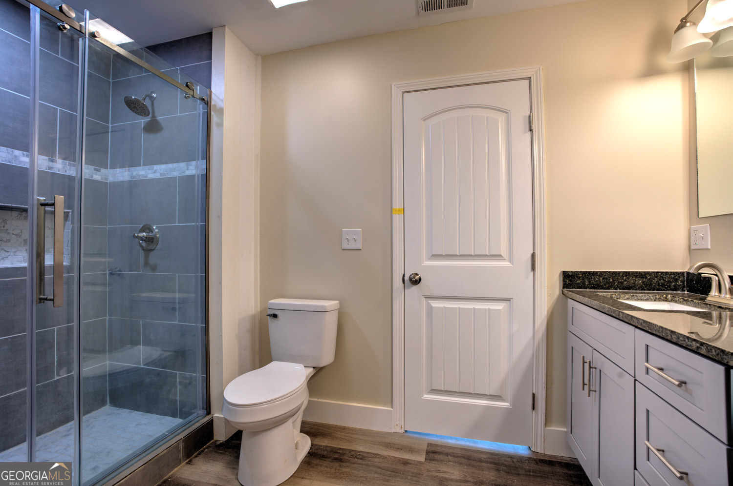 136 Key Lane Lakemont, GA 30552 - Photo 26 of 33 a bathroom with a granite countertop toilet a sink and shower