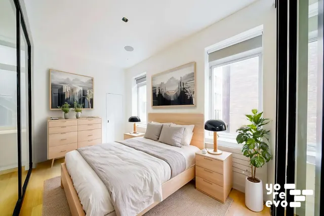 a bedroom with bed and window