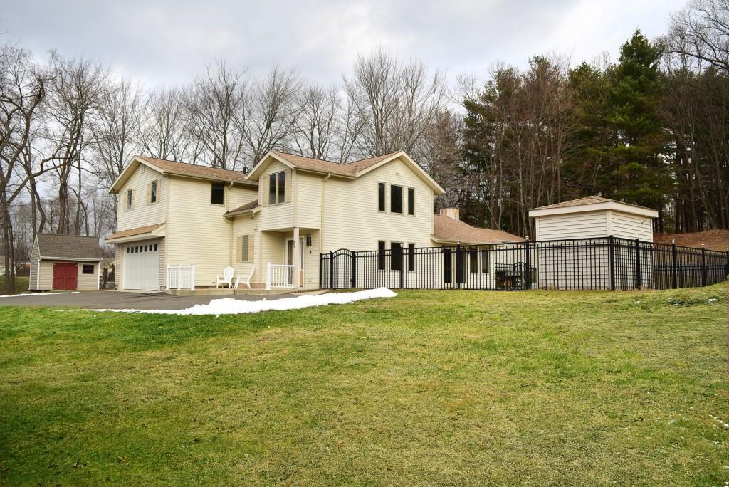 26 Hicksville Road Cromwell, CT 06416 - Photo 1 of 1 a white house that has a tree in front of it