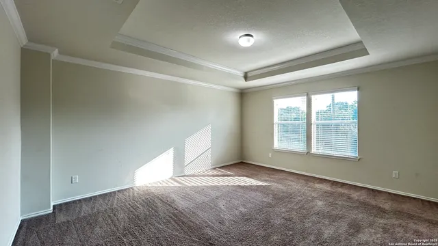 an empty room with a empty space and windows