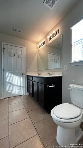 a bathroom with a toilet a sink and mirror