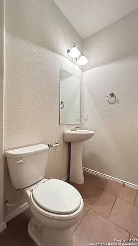 a white toilet sitting next to a bathroom sink