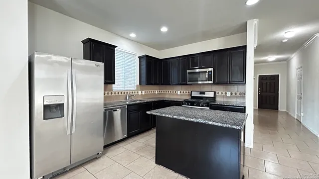 a kitchen with a refrigerator sink and microwave
