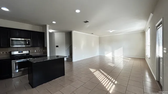 a view of a kitchen with a sink and cabinets
