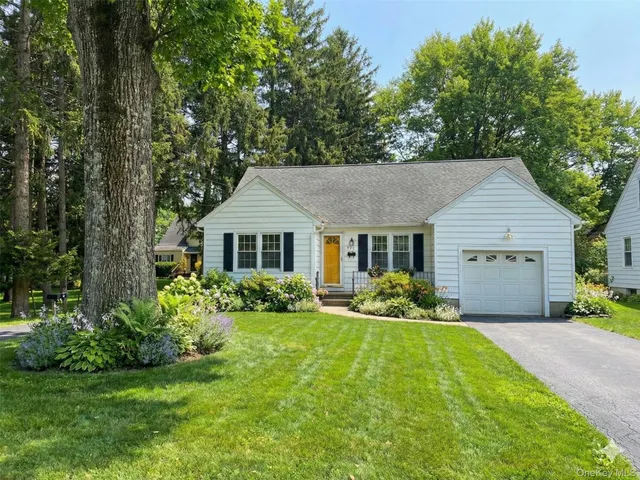 a aerial view of a house with yard and green space