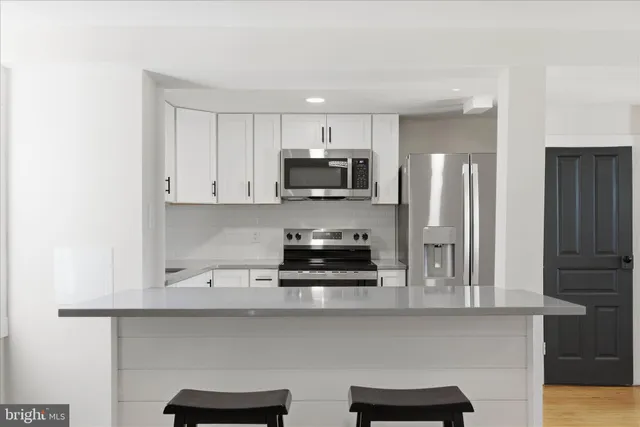 a view of a hallway with wooden floor and entryway