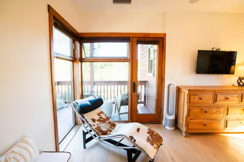 a view of a porch with furniture and wooden floor