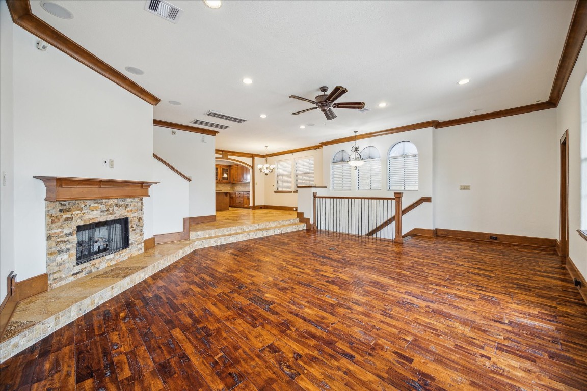 a view of a livingroom with wooden floor and a fireplace