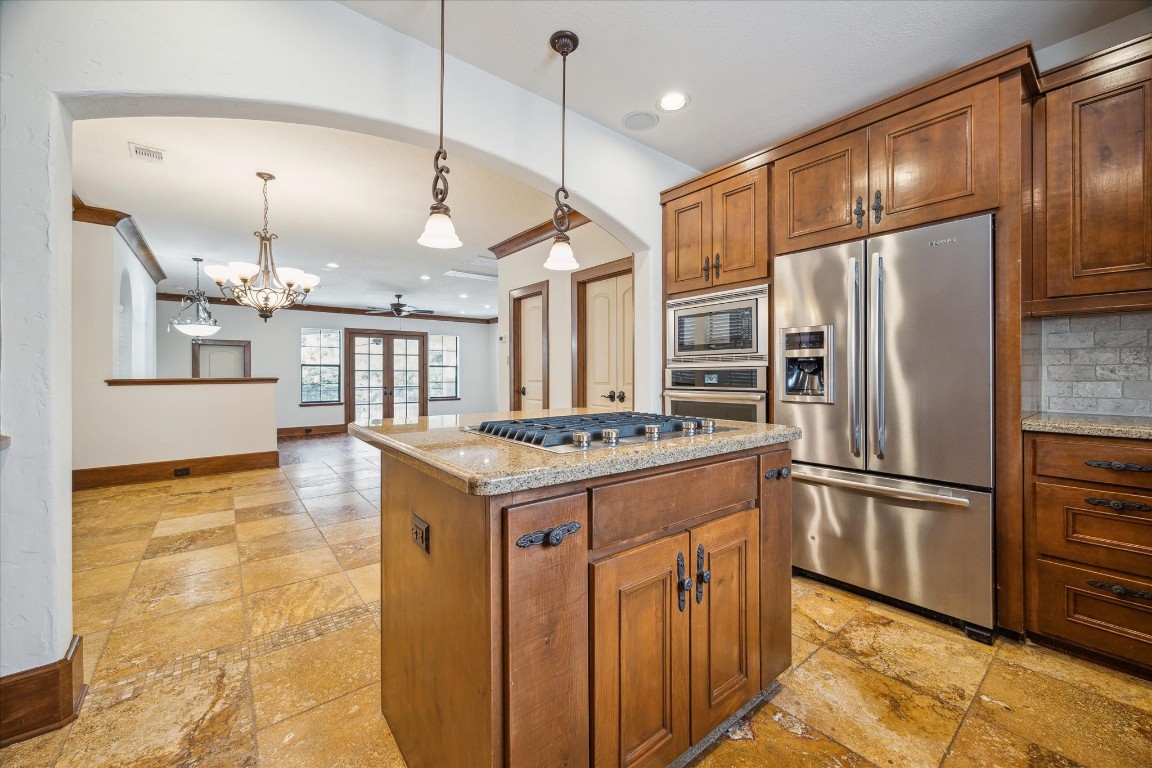 3614 Lancashire Street Houston, TX 77027 - Photo 20 of 47 a kitchen with granite countertop a refrigerator and a stove top oven