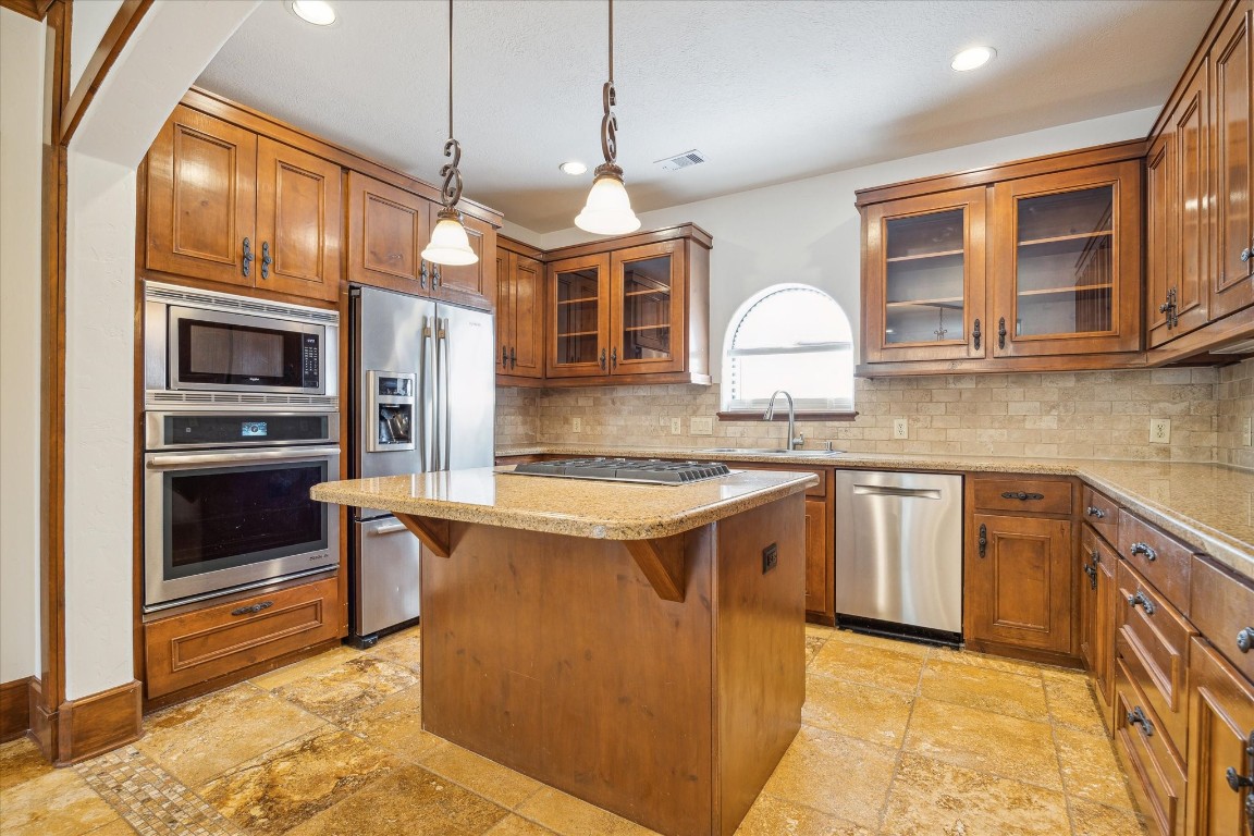 3614 Lancashire Street Houston, TX 77027 - Photo 21 of 47 a kitchen with stainless steel appliances granite countertop a stove a sink and a refrigerator