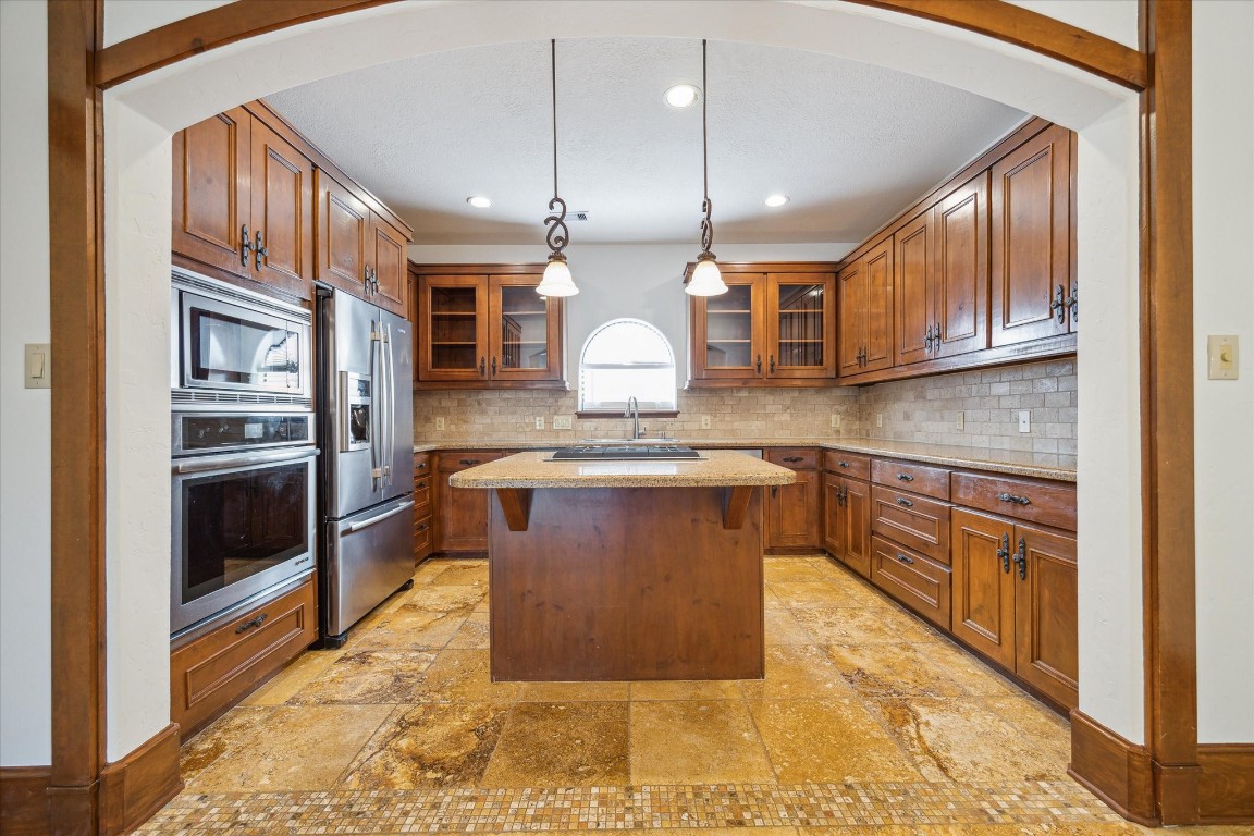 3614 Lancashire Street Houston, TX 77027 - Photo 22 of 47 a kitchen with stainless steel appliances granite countertop a stove a sink and a refrigerator