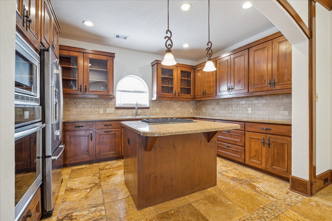 3614 Lancashire Street Houston, TX 77027 - Photo 23 of 47 a kitchen with stainless steel appliances granite countertop a sink a stove and a wooden cabinets