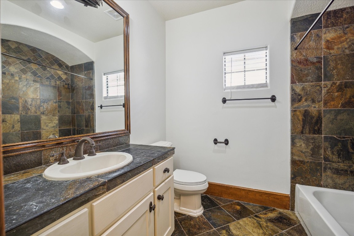 3614 Lancashire Street Houston, TX 77027 - Photo 39 of 47 a bathroom with a granite countertop sink a toilet and shower