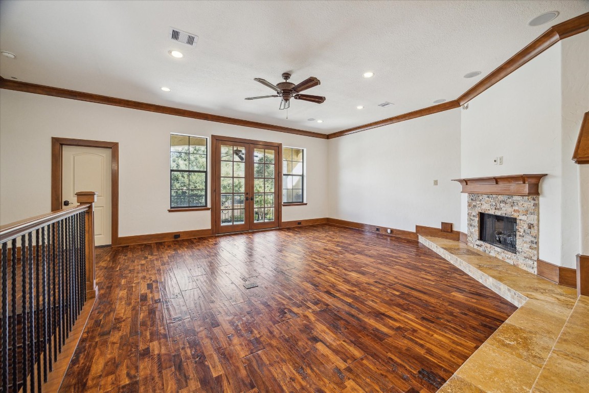 3614 Lancashire Street Houston, TX 77027 - Photo 9 of 47 a view of a livingroom with wooden floor a fireplace and windows