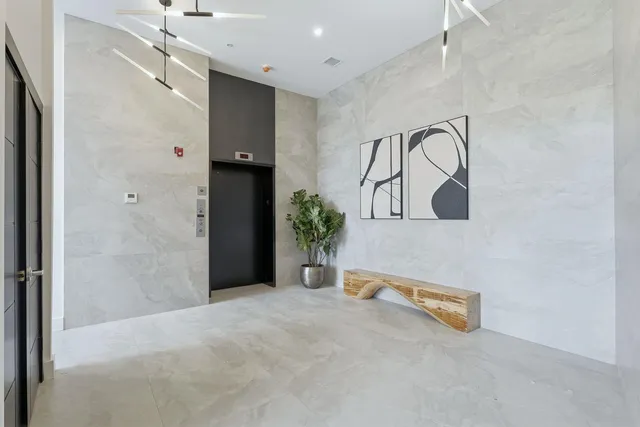 a view of a room with a sink and mirror