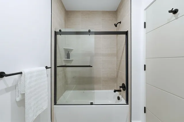 a bathroom with a glass shower door