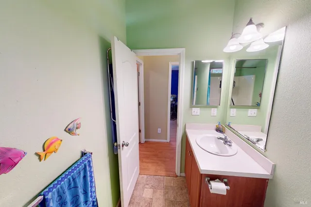 a bathroom with a sink a mirror and a shower