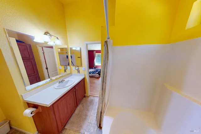 a bathroom with a sink a mirror and vanity