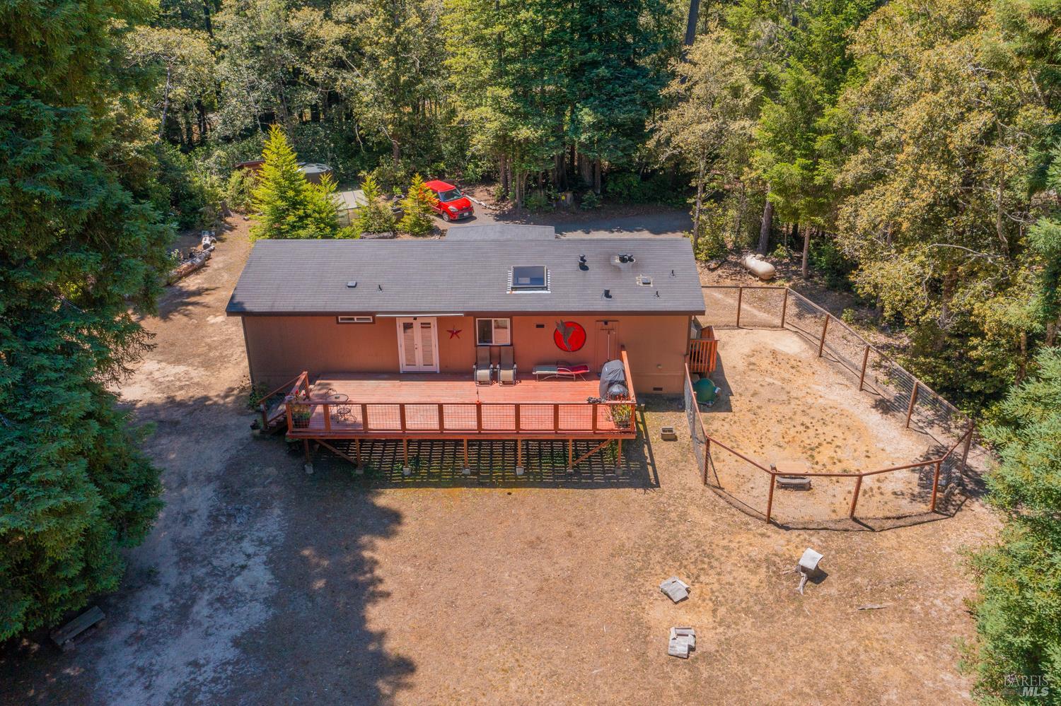 28001 Tenmile Road Gualala, CA 95445 - Photo 2 of 32 an aerial view of a house with swimming pool and large trees