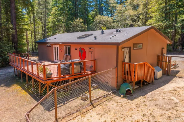a view of a roof deck with couches and wooden fence