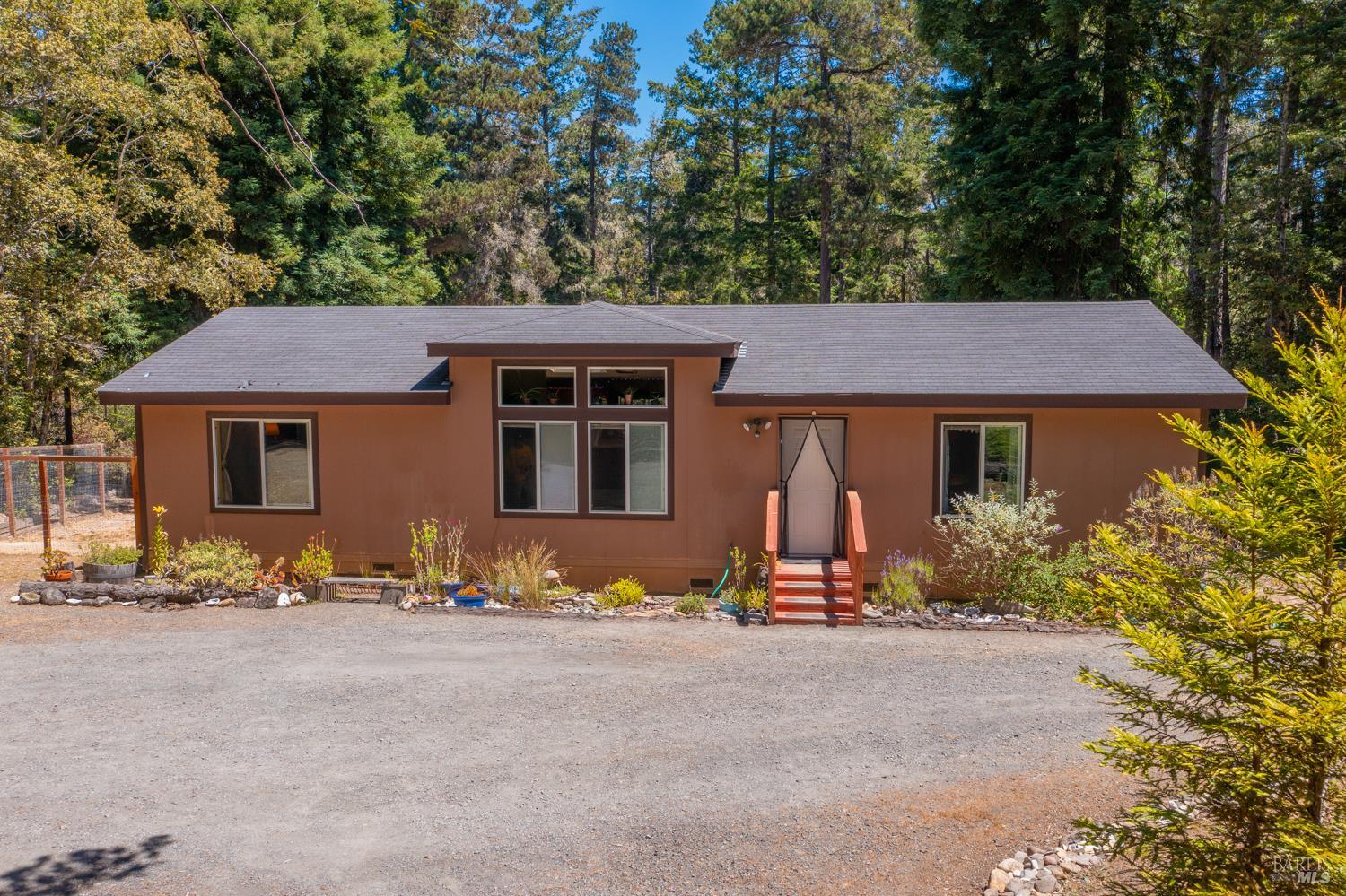 28001 Tenmile Road Gualala, CA 95445 - Photo 27 of 32 a front view of a house with a yard