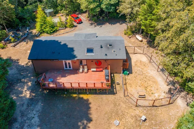 an aerial view of a house with a yard