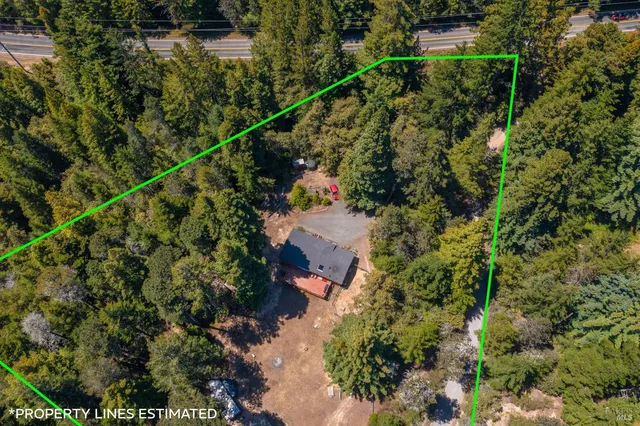 an aerial view of a house with a yard