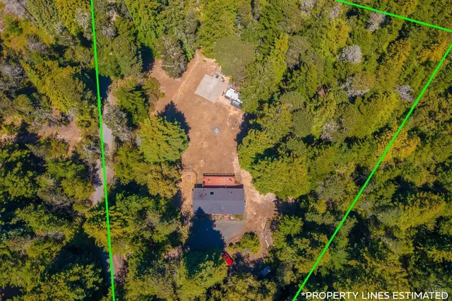 an aerial view of a house with a yard and garden