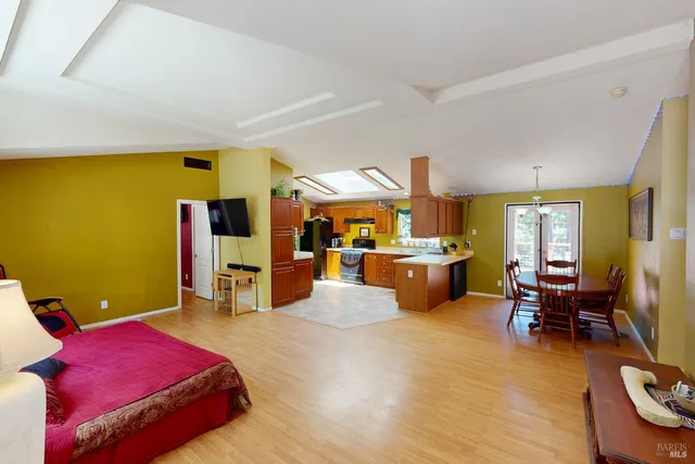 a bedroom with furniture and a large window