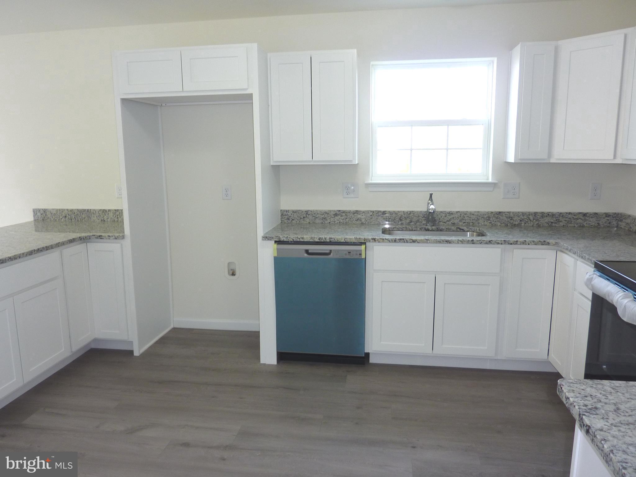 272 Doylestown Road Smyrna, DE 19977 - Photo 12 of 34 a kitchen with granite countertop white cabinets stainless steel appliances a sink and a window