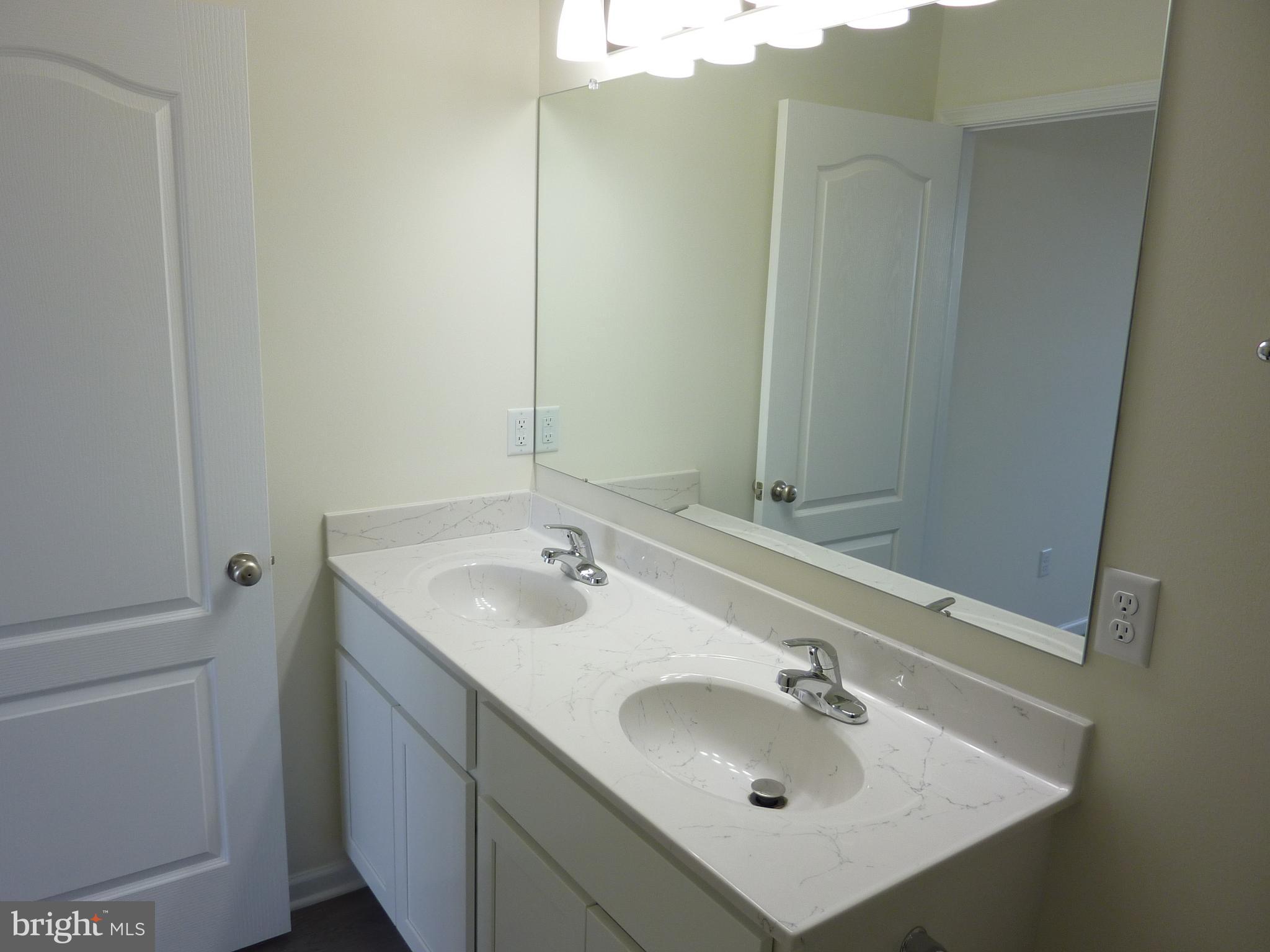 272 Doylestown Road Smyrna, DE 19977 - Photo 20 of 34 a bathroom with a sink and a mirror