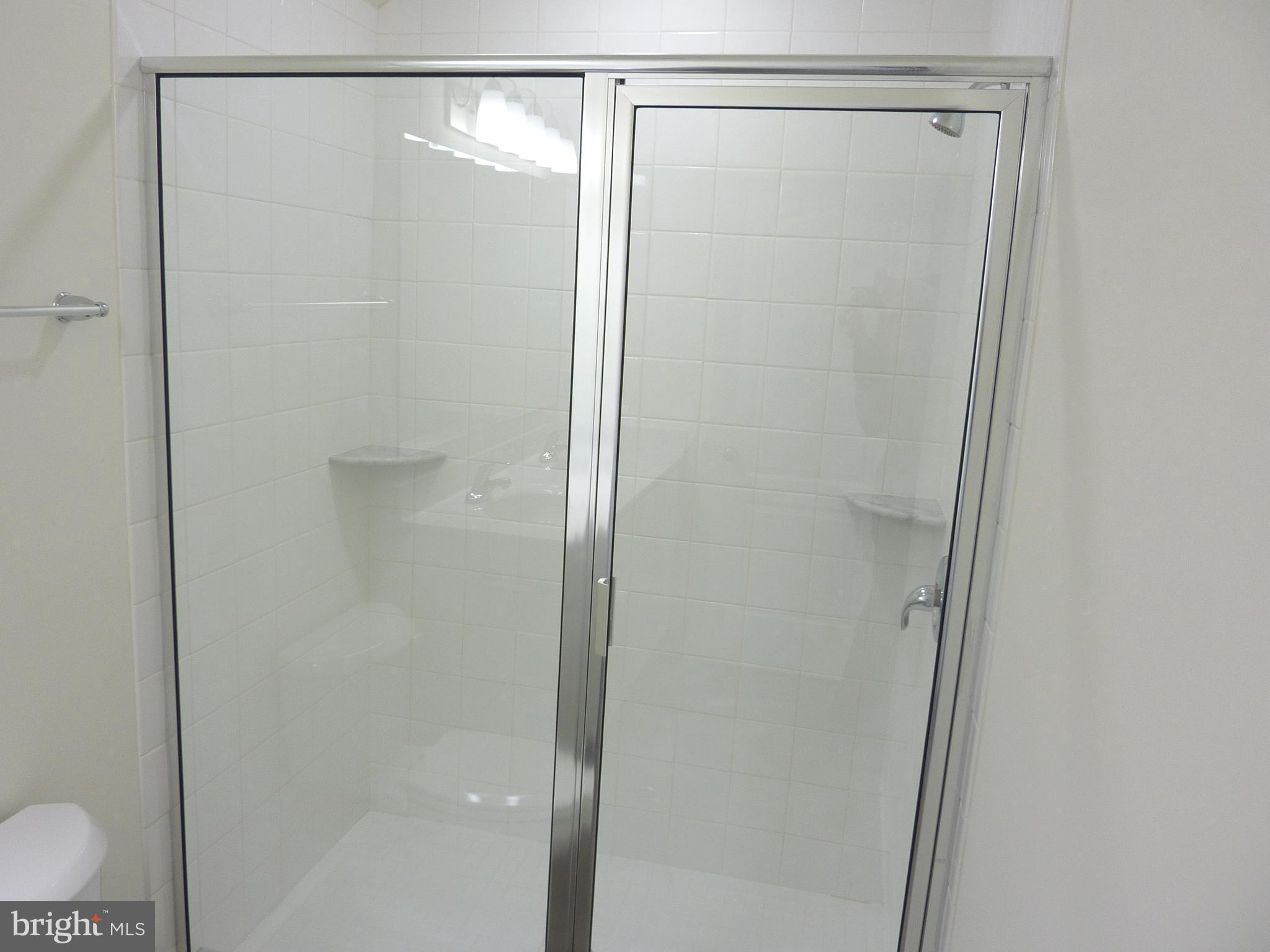 272 Doylestown Road Smyrna, DE 19977 - Photo 21 of 34 a bathroom with a glass shower door