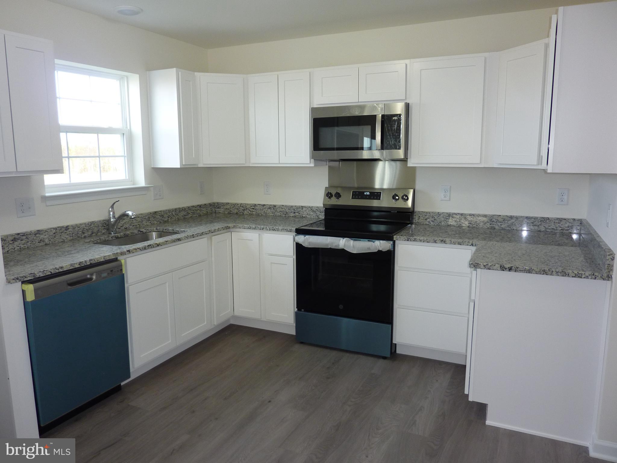 272 Doylestown Road Smyrna, DE 19977 - Photo 10 of 34 a kitchen with sink a microwave and cabinets