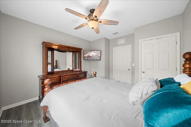 a bedroom with a large bed and a chandelier