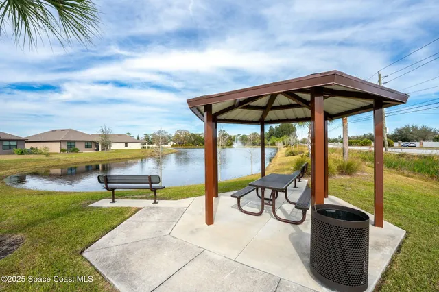 an aerial view of a city with lots of residential buildings and ocean view in back