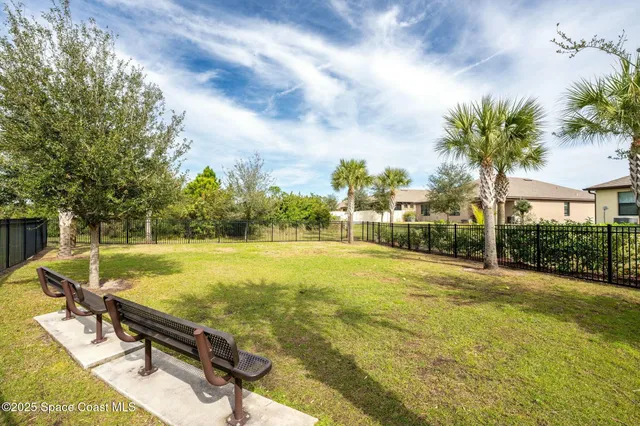 an aerial view of multiple houses with a yard