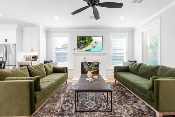 a living room with furniture a fireplace and a window
