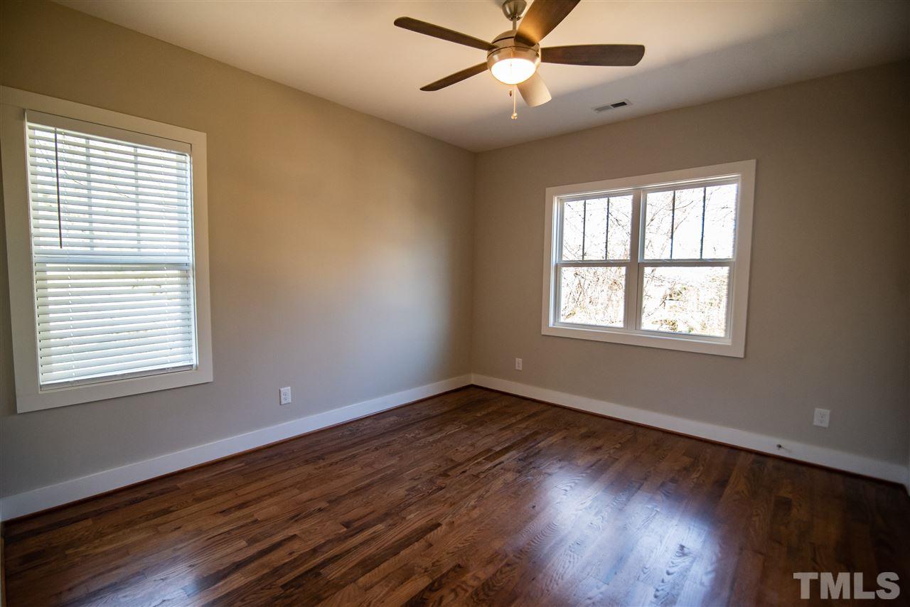 1513 East Lane Street Raleigh, NC 27610 - Photo 22 of 25 a view of an empty room with wooden floor and a window