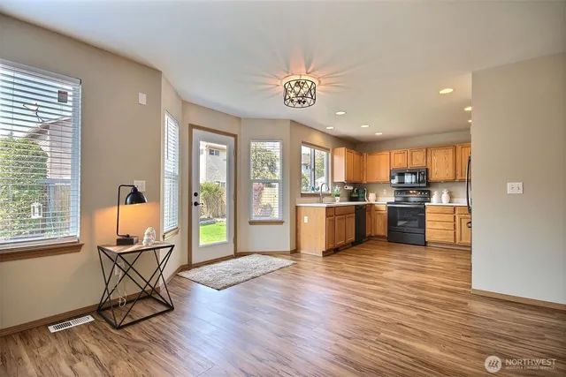a view of a kitchen with furniture and a wooden floor