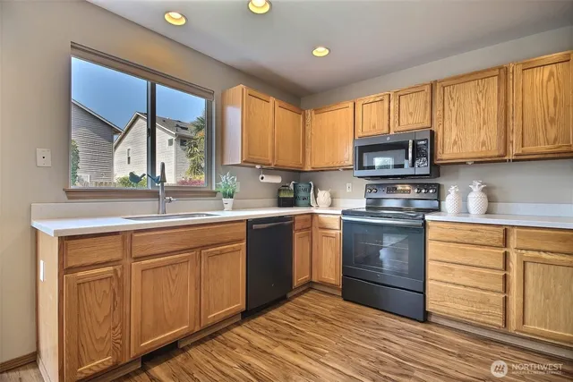 a kitchen with a stove a sink and a microwave