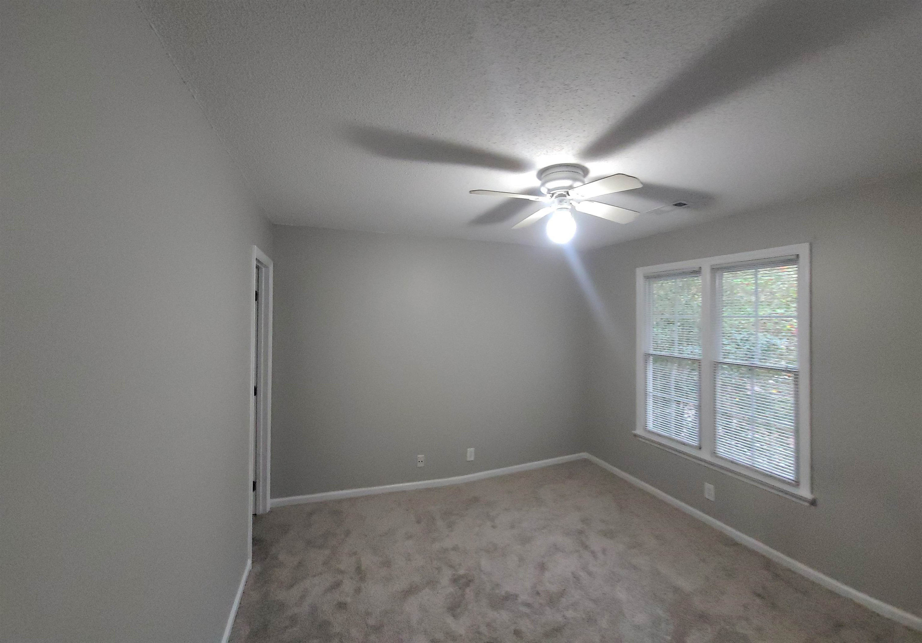 3809 Axle Lane Raleigh, NC 27616 - Photo 20 of 30 an empty room with windows and fan