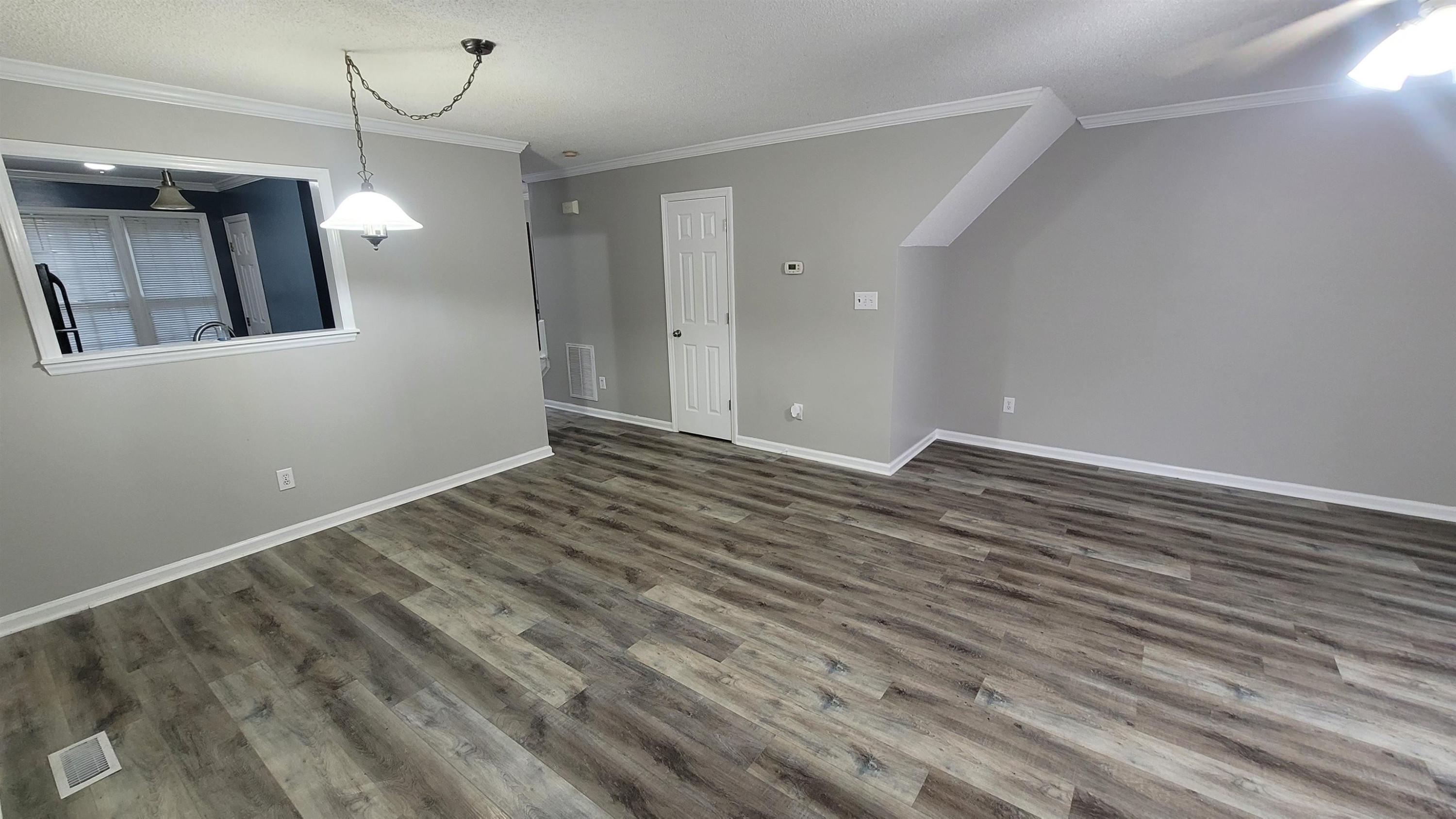 3809 Axle Lane Raleigh, NC 27616 - Photo 25 of 30 a view of an empty room with wooden floor and a window